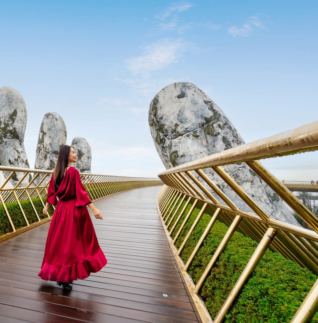 Traveller walking across the Golden Bridge at Ba Na Hills, Vietnam